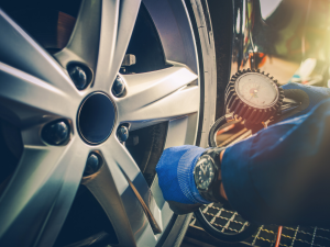 It is vital to check your vehicle's tire pressure regularly to improve handling and your safety on the road. If you ensure that your tires are always inflated to the proper pressure levels, it will save you money on gas and extend the life of your tires. In this article, your Nissan dealer explains how to check the tire pressure on your car and ensure they are inflated to the correct PSI.  Perform Tire Pressure Checks on Cold Tires Wait for the tires to cool down before you do a tire pressure check. A tire pressure reading will be affected if the tires are hot. Wait two to three hours for tires to cool down before checking the tire pressure. Find the Correct PSI You need to know the correct tire pressure level for each tire on your vehicle. You will find the correct PSI for your vehicle's tires on a sticker inside your driver's door. Your vehicle's owner's manual will also have information on the recommended tire pressure levels. If the tire pressure levels between the front and rear tires differ, write down the PSI for each tire on a piece of paper. Use a Tire Pressure Gauge Check the PSI of each tire with an analog or digital tire pressure gauge. An analog dial tire pressure gauge has a dial face with measurements, and an analog pen tire pressure gauge has a stick with numbers or a bar that moves upward to indicate the tire pressure level. The easiest is to use a battery-powered digital tire pressure gauge that gives a digital reading. Measuring the Tire Pressure You can start with any one of the tires on your car. Remove the valve cap and keep it in a safe place. Take your tire pressure gauge and press it against the valve stem until you hear a hissing sound. Hold the tire pressure gauge in place until you get a tire pressure reading. A digital tire pressure gauge will display the reading on a screen. The dial on a standard meter will point to the pressure, or a bar will move upward to show the tire pressure level. Write Down the Reading Write down the reading next to the recommended PSI for that specific tire. Perform a tire pressure reading on the rest of the tires. Remember to write down the reading next to the PSI for each tire. When you measure the tire pressure level of a tire, and it's correct, you can replace the valve cap. If you need to inflate the tire, keep the valve cap in a safe place until after you've increased the level to the correct PSI. Inflate the Tires You now have the tire pressure readings of all four tires. Compare the reading of each tire to the correct tire pressure level that you wrote down on the piece of paper. If the PSI of a tire is lower than the recommended tire pressure level, inflate the tire until it reaches the correct level. It's important not to overinflate the tires as it could cause damage to the tire. If you notice a tire is overinflated, you can push the back of the tire pressure gauge down on the metal pin in the valve stem to release the excess air. Replace the valve cap when the tire is inflated to the correct tire pressure level. Always keep your tires inflated to the correct tire pressure levels to prevent blowouts, decrease wear, and save you money on gas. We're passionate about offering you all of the most valuable automotive information here at DARCARS Nissan of Rockville. So if you don't want to stop there, check out our tips & tricks blogs to keep learning today!