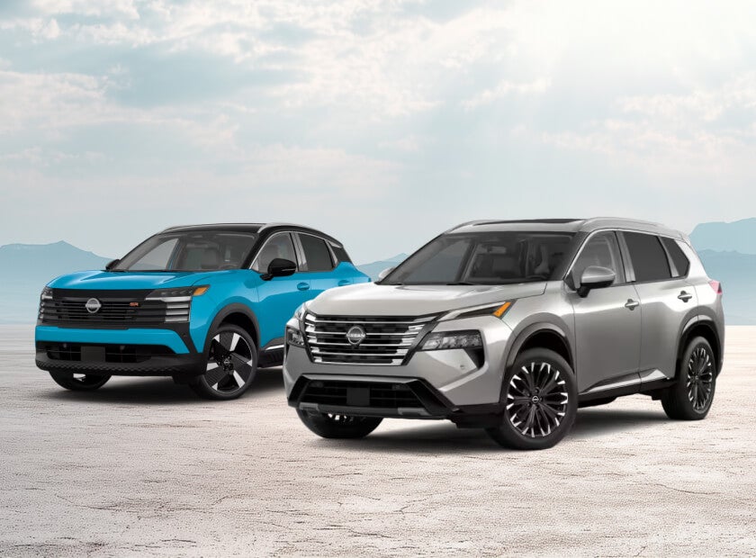 2027 Nissan Kicks SR in Arctic Ice Blue/Black and 2026 Rogue Platinum in Champagne Silver, posed under a bright sky.