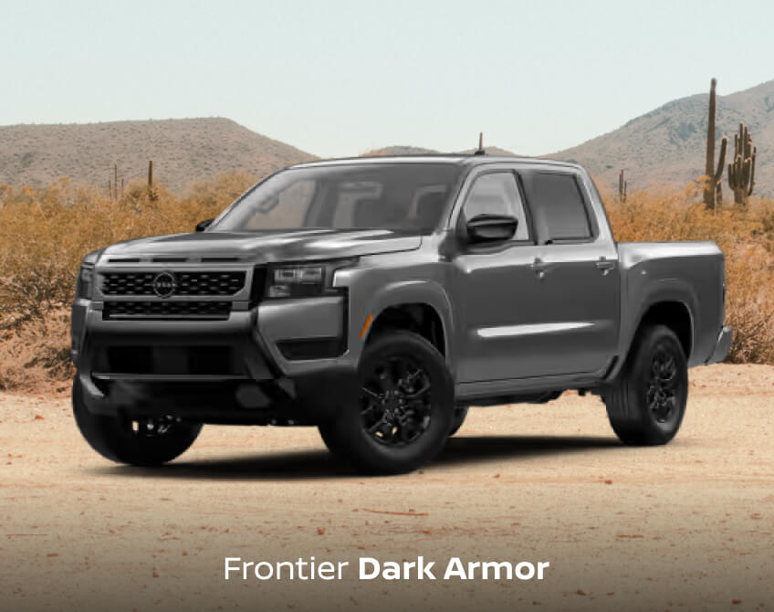 Front three-quarter view of a dark grey Nissan Frontier Dark Armor in a desert.